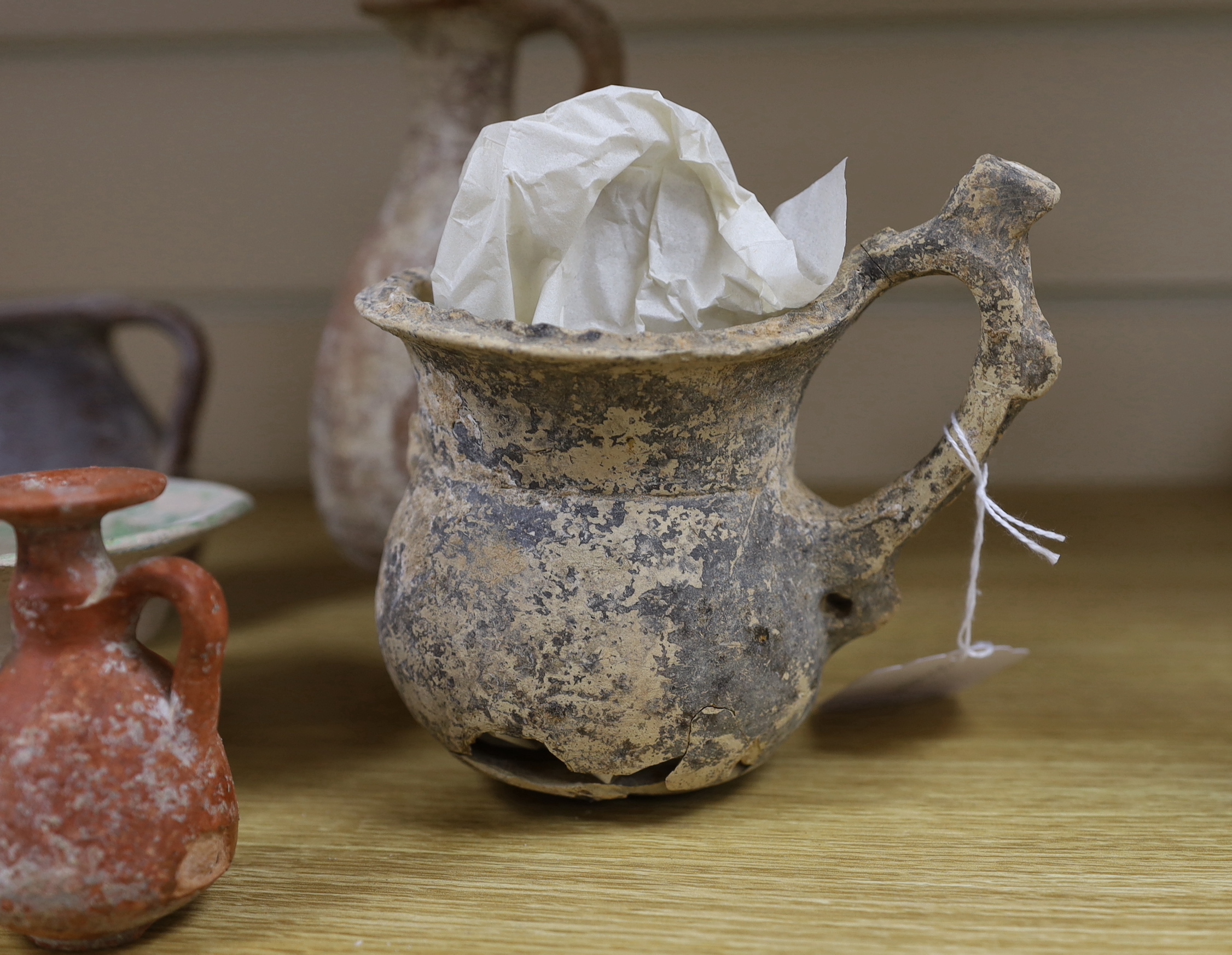 A group of pottery ‘antiquities’, to include Roman, early Christian, Byzantine and Syrian, the largest 17cm high (9), provenance: the owner collected these items in the 1970s, some with original receipts